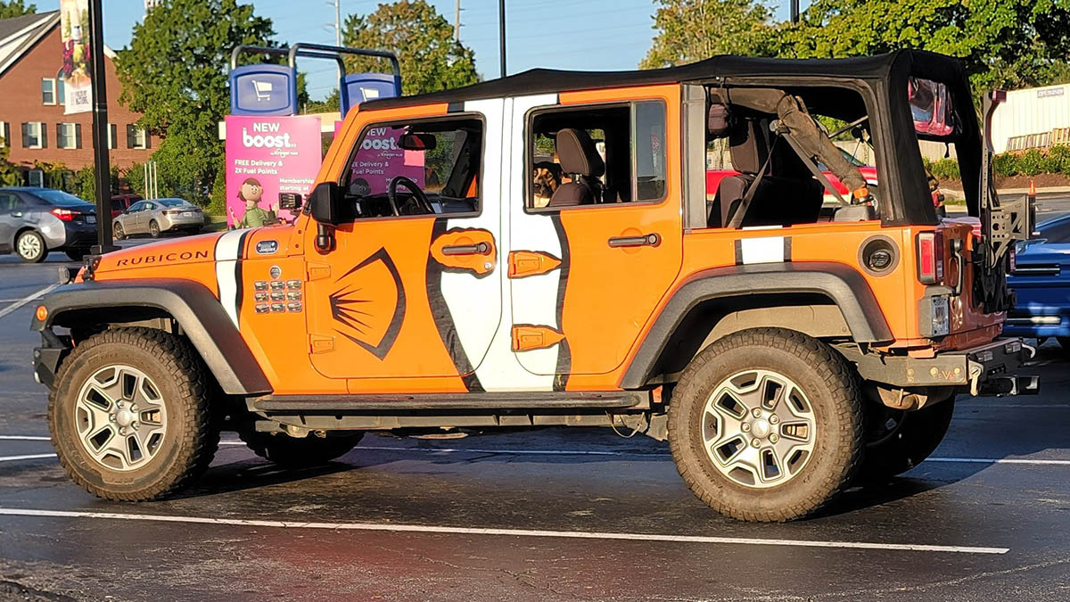 Jeep Wrangler Rubicon with orange and white Nemo-style car wrap.