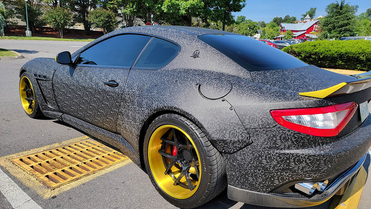 Black and gray matte pattern car wrap on Maserati coupe.