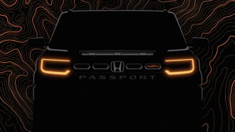A teaser photo showing the front end of the 2026 Honda Passport, in heavy shadows