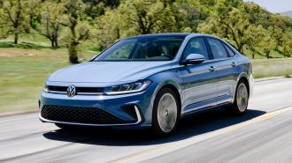 2025 Volkswagen Jetta driving on a road.