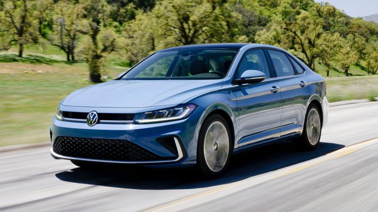 2025 Volkswagen Jetta driving on a road.