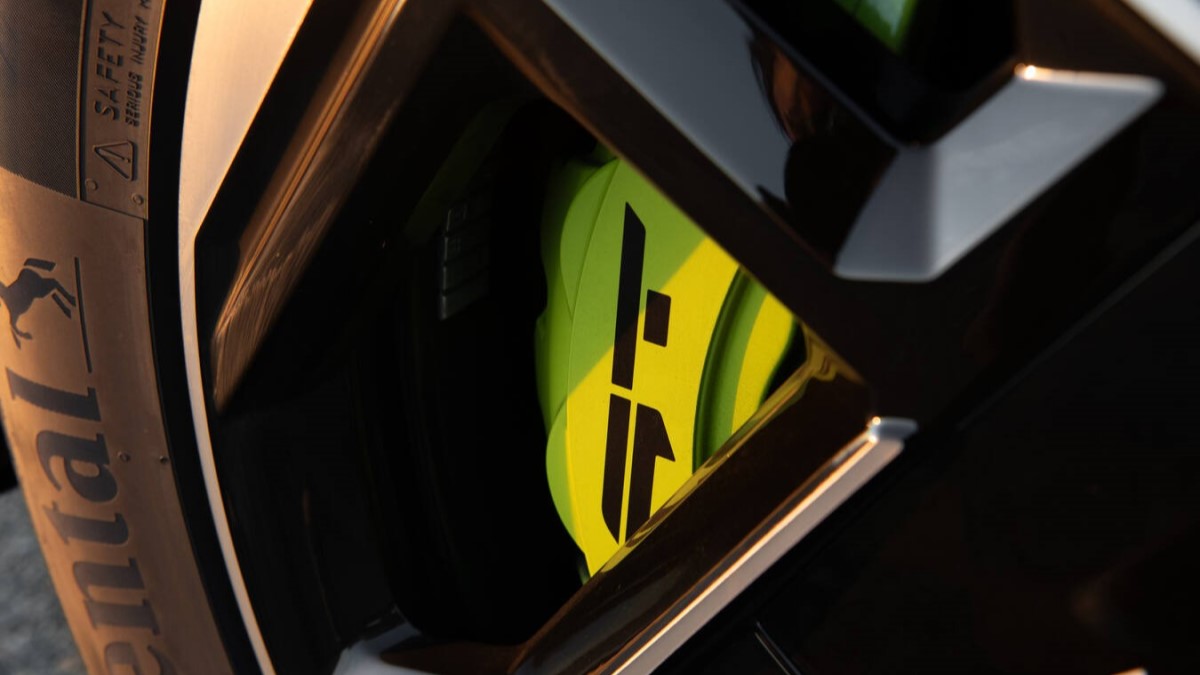 A detail shot showing the painted brake calipers of the 2026 Kia EV9 GT