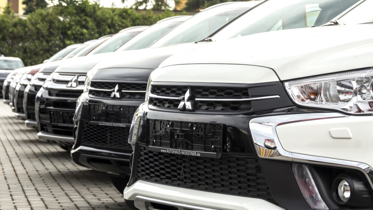 A line of cars at a Mitsubishi dealership