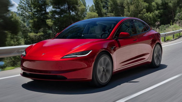 2025 Tesla Model 3 driving on a road.