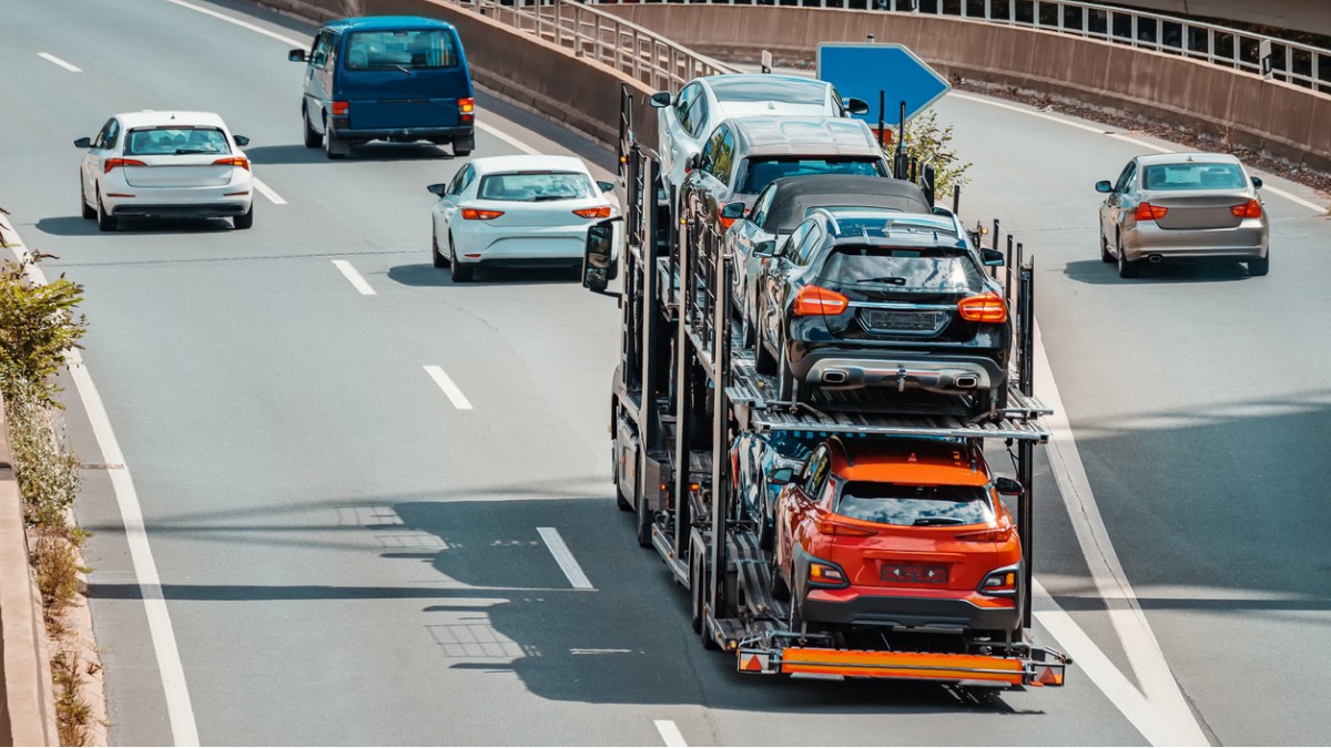 A car carrier loaded with new cars on a highway