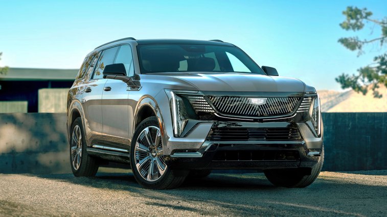 2026 Cadiilac Escalade IQL parked near a house.