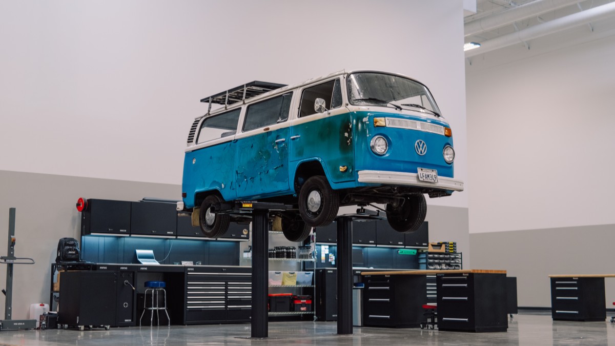 Azul, a 1977 Volkswagen Type 2 that survived the 2025 California wildfires, on a lift awaiting restoration work